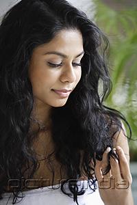 PictureIndia - Indian woman looking at her hair