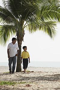 PictureIndia - Father and son walking along the sea