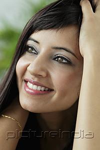 PictureIndia - head shot of woman with hands in hair smiling