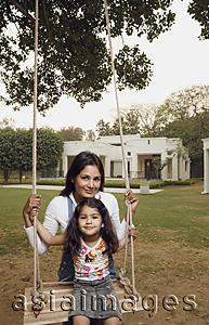 Asia Images Group - mother with girl on swing