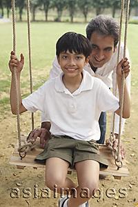 Asia Images Group - father with son on swing