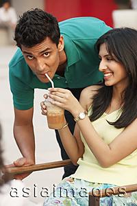 Asia Images Group - girlfriend sharing drink with boyfriend