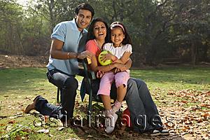 Asia Images Group - Family in park, girl holding yellow balloon