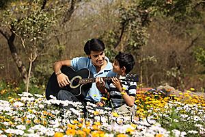 Asia Images Group - Father and son with guitar outside