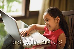 Asia Images Group - little girl working at laptop (horizontal)