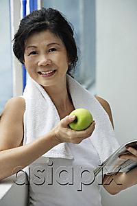 AsiaPix - Woman eating apple after work out