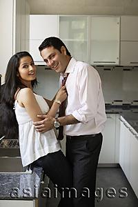 Asia Images Group - young couple flirting in kitchen