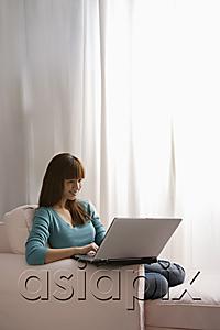 AsiaPix - Asian girl with laptop at home