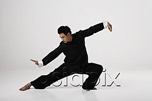 AsiaPix - Man doing Tai Chi wearing traditional Chinese clothes