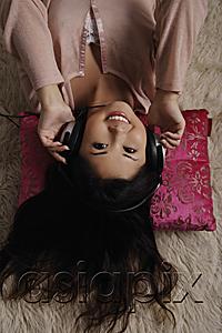 AsiaPix - Chinese woman laying on floor listening to music