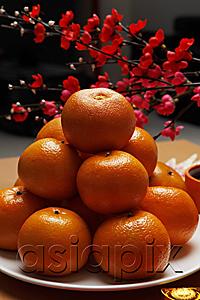 AsiaPix - Oranges stacked on plate