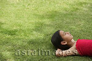 Asia Images Group - girl lying on back in grass