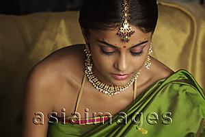Asia Images Group - woman wearing sari and decorated with traditional jewelry and bindi