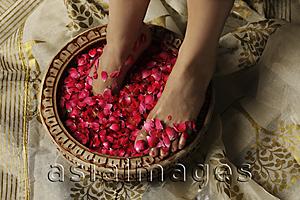 Asia Images Group - woman's feet soaking in rose petals and rose water