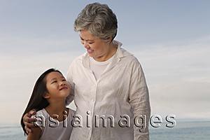 Asia Images Group - Older woman looking at young girl.