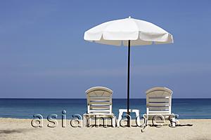 Asia Images Group - White umbrella and chairs on beach