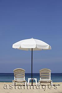 Asia Images Group - White umbrella and chairs on beach