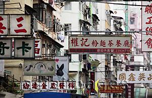 Asia Images Group - Chinese signs hanging above busy street