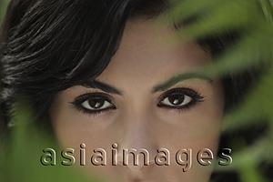 Asia Images Group - Cropped head shot showing just eyes and nose of young woman.