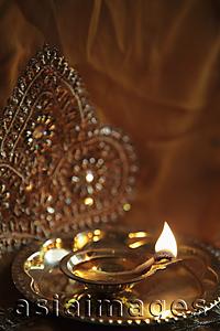 Asia Images Group - Bronze oil lamp with flame
