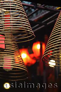 Asia Images Group - Incense coils with red lanterns in background