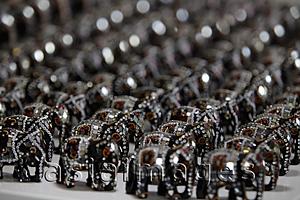 Asia Images Group - Rows of elephant figurines decorated with mirrors and beads