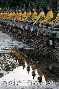 Asia Images Group - Stone Buddhas in a row reflecting in water, Wat Yai Chaya Mongkol
