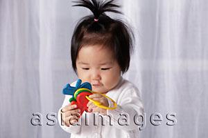 Asia Images Group - Chinese baby holding toy key ring