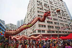 Asia Images Group - Traditional Chinese Dragon dance being performed on the street, Tai Kok Tsui Temple Fair. Hong Kong, China