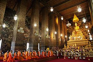 Asia Images Group - Monks Praying in the main room of Wat Pho, Bangkok, Thailand.