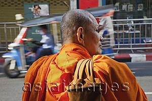 Asia Images Group - Rear view of Monk standing by side of road. Bangkok, Thailand