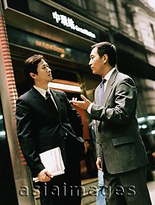 Asia Images Group - Executive pair talking on street.