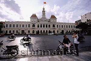 Asia Images Group - Vietnam, Ho Chi Minh City, Hotel De Ville (People's committee Building), people on motorcycles in foreground.