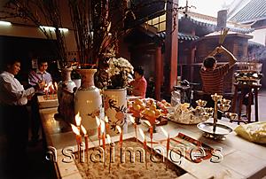Asia Images Group - Malaysia, Kuala Lumpur, Chinatown, Devotees praying at Chinese temple.