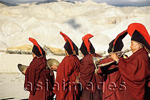 Asia Images Group - Nepal, Mustang, Buddhist lamas play their instruments in a procession to toss out evil spirits.