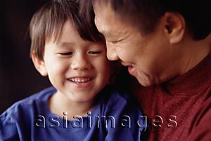 Asia Images Group - Young boy held by father, laughing