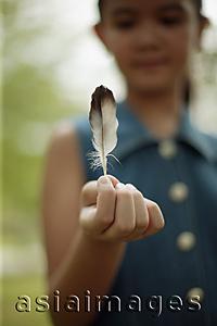 Asia Images Group - Young girl holding a feather