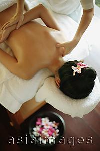 Asia Images Group - Young woman at a spa, being massaged