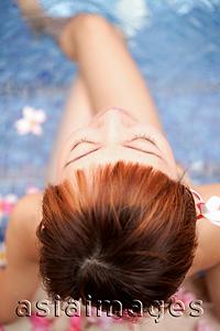 Asia Images Group - Young woman sitting at edge of pool, directly above