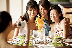 Asia Images Group - Group of young women, sitting down at cafe, posing for camera