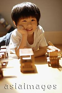 Asia Images Group - Young boy with hands on chin, looking at camera