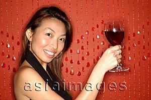 Asia Images Group - Woman holding wine glass, smiling
