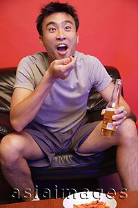 Asia Images Group - Young man watching TV