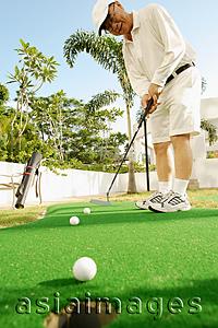 Asia Images Group - Senior man holding golf club, playing golf