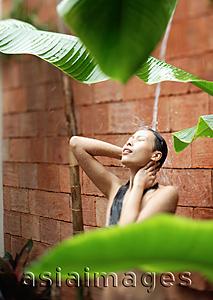 Asia Images Group - Woman taking a shower, outdoors