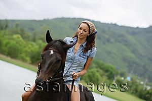 Asia Images Group - Woman riding horse