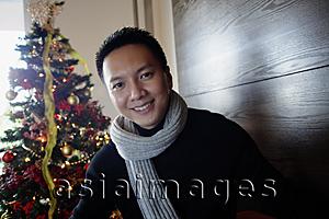 Asia Images Group - Man in sweater and scarf, smiling at camera