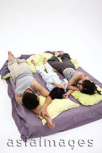 Asia Images Group - Family with one child, sleeping on bed