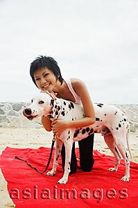 Asia Images Group - Woman with Dalmatian on beach