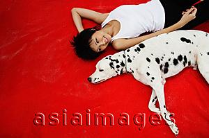 Asia Images Group - Woman with Dalmatian on red blanket